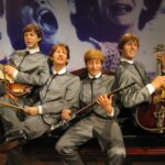 File:The Beatles wax dummes (2).jpg - the man is wearing a suit